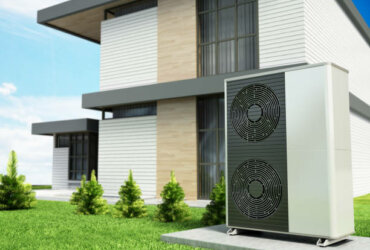 Heat pumps outside the modern house, installed near the wall.